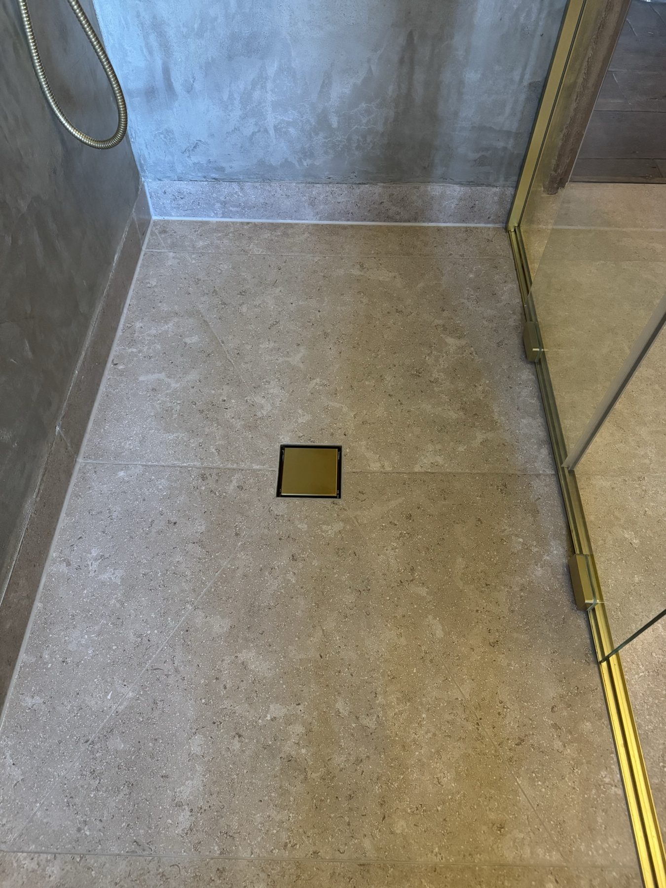 Heated stone-effect shower floor with brass drain – Bramble Farmhouse bathroom renovation, Wye, Kent